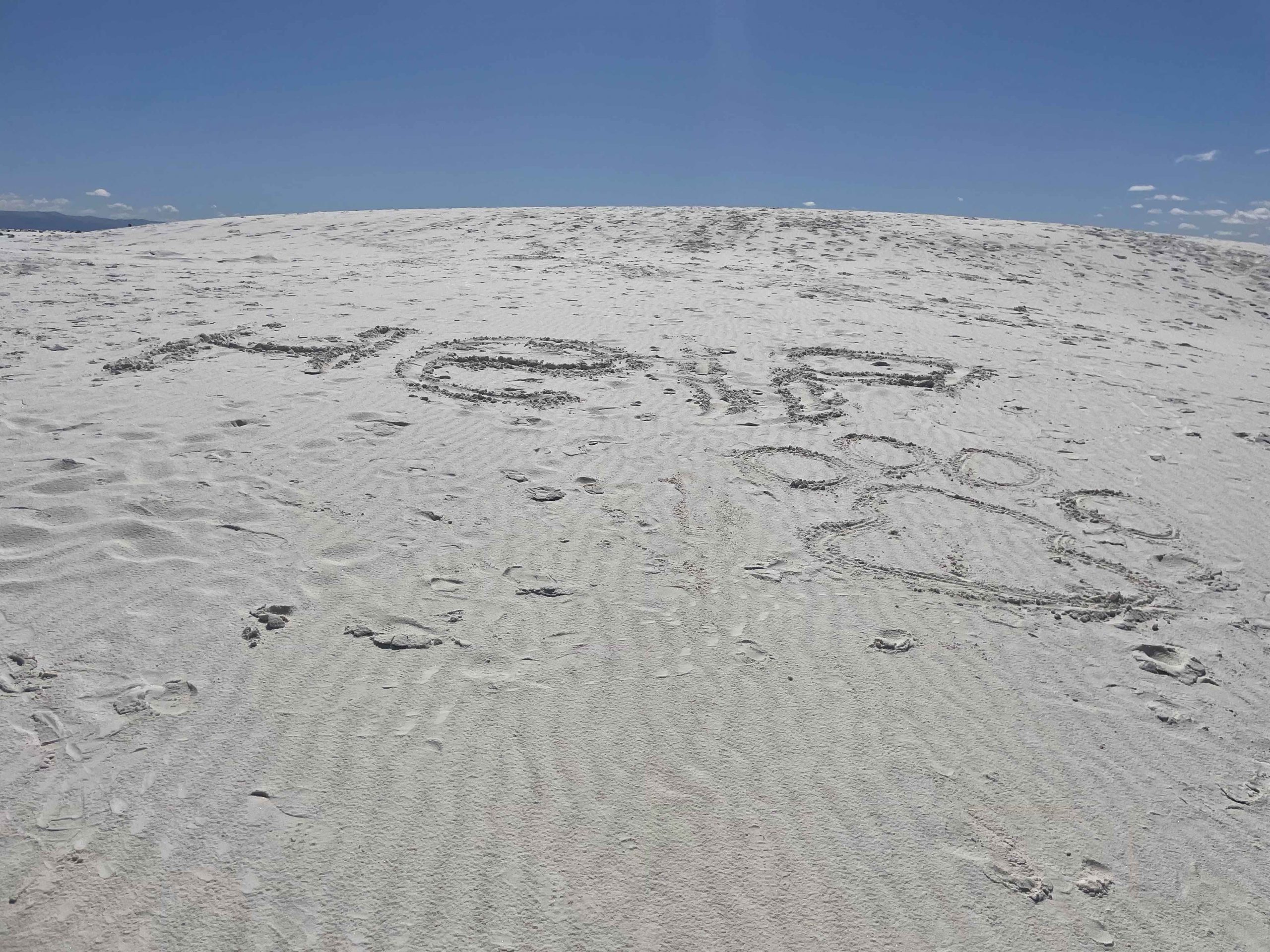 Image in the sand asking for help