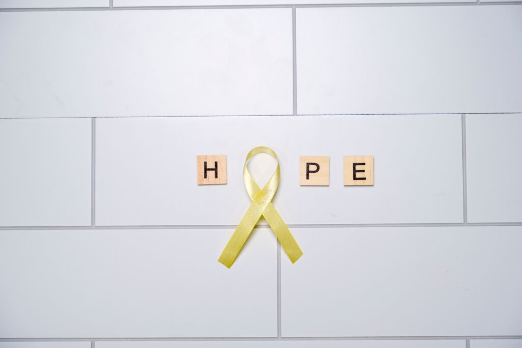 Hope in Scrabble tiles with Yellow ribbon as O
