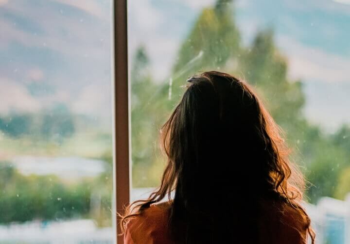 girl looking out of her window