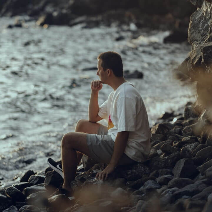 man looking at a view of the water