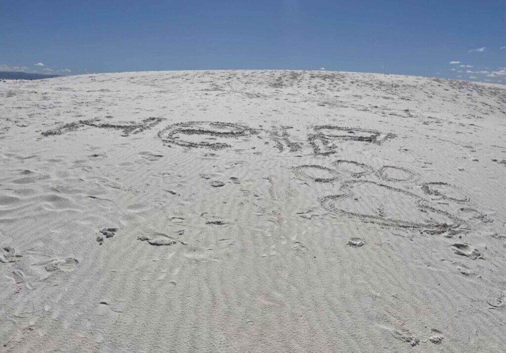 Image in the sand asking for help